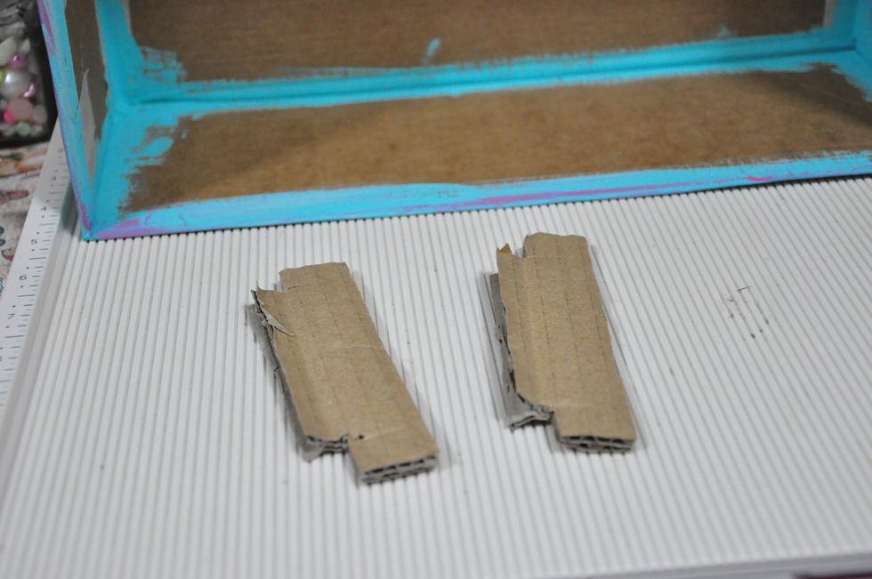 Cut slits at the sides of the box. Do this to the 2 cardboard strips and insert to the slit