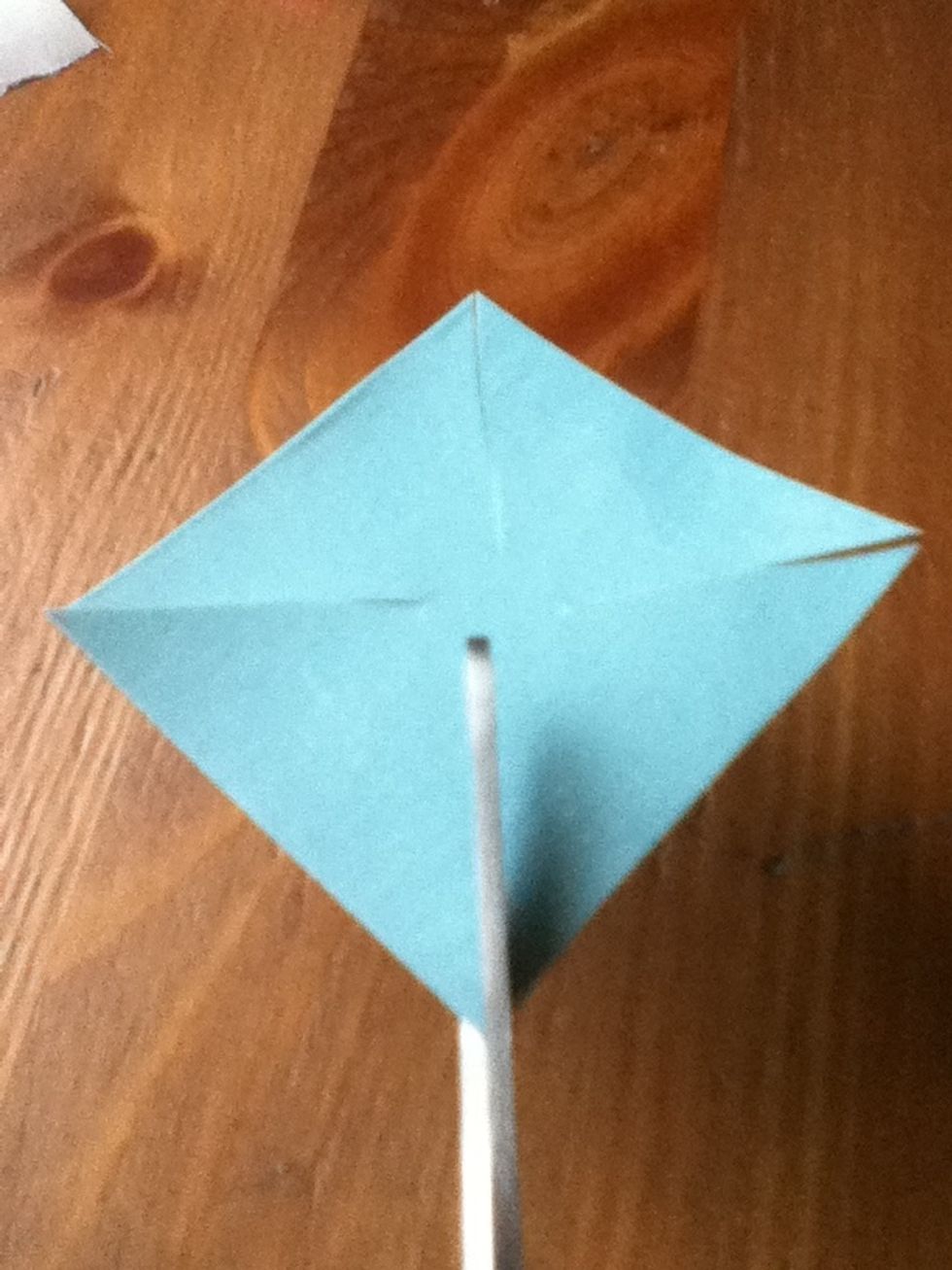 Cut slits on corners that go relatively close to the center, but leave room for a glue dot.