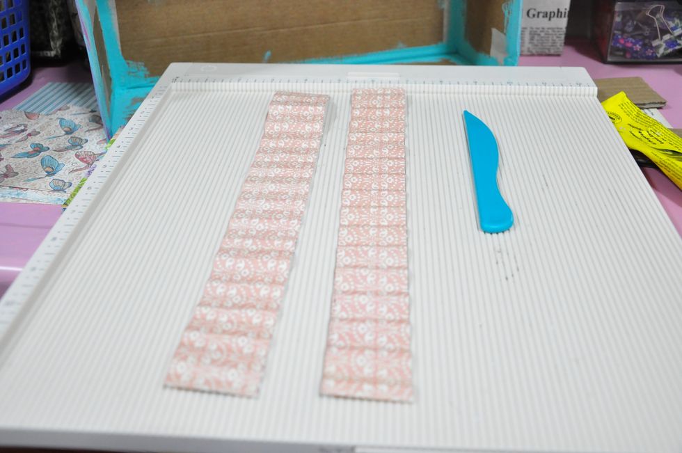 Cut some 1.5 inches strips of paper. Score at .5 and fold as seen in the image