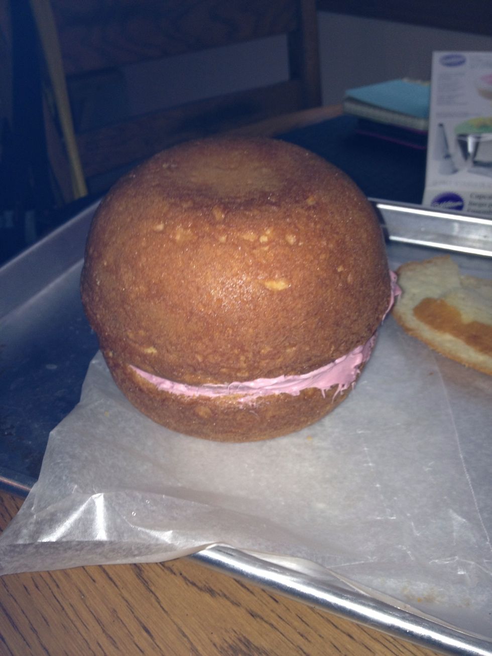 Cut some off cake so i fits and makes a round ball. Use frosting or your preferred filler to fuse both sides of cake together.