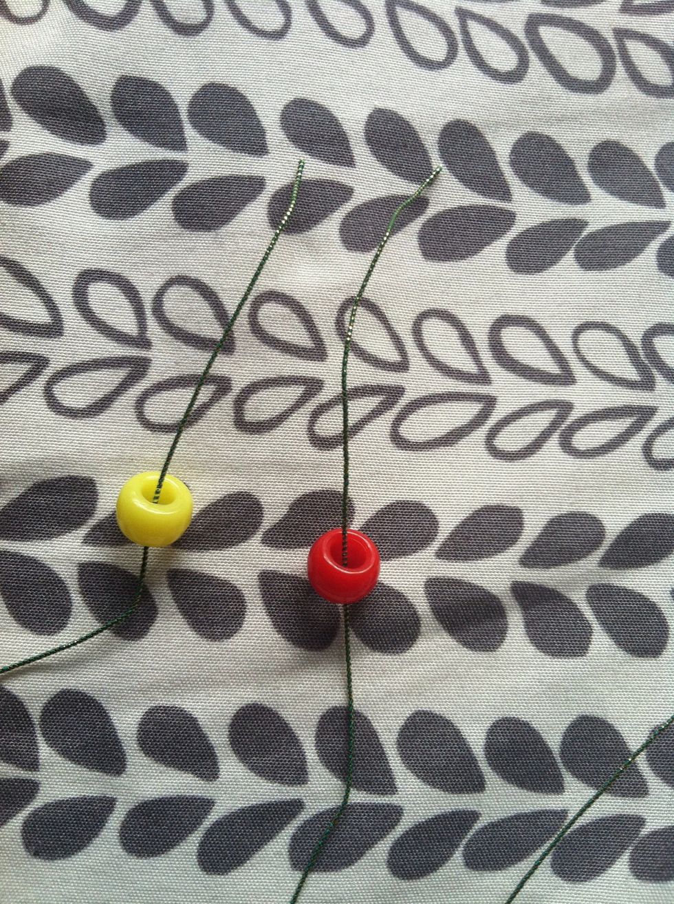 Cut some string the length of fingertip to shoulder blade, put the strings in half and add 2 beads each string.