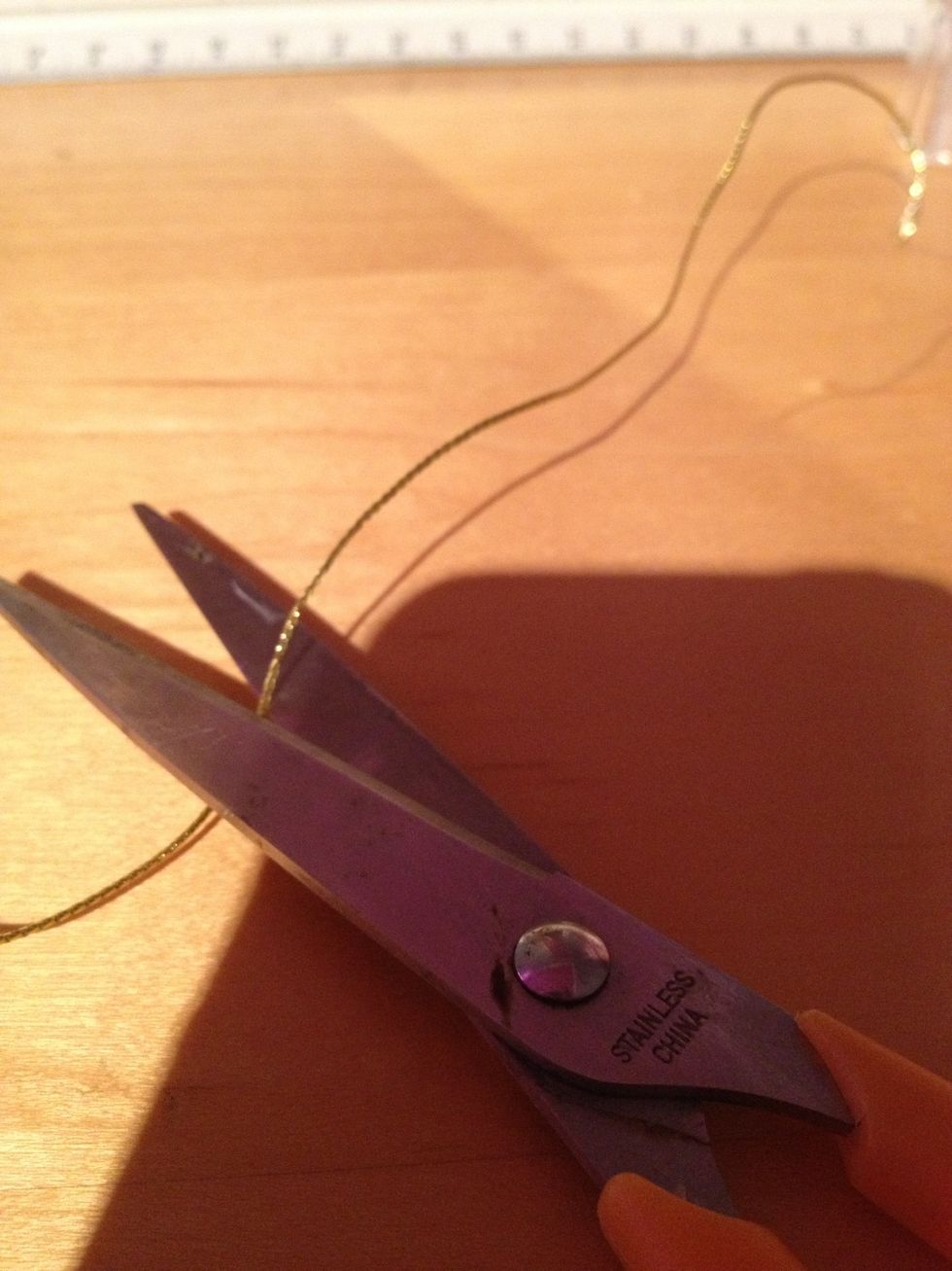 Cut some string to tie around the ribbon