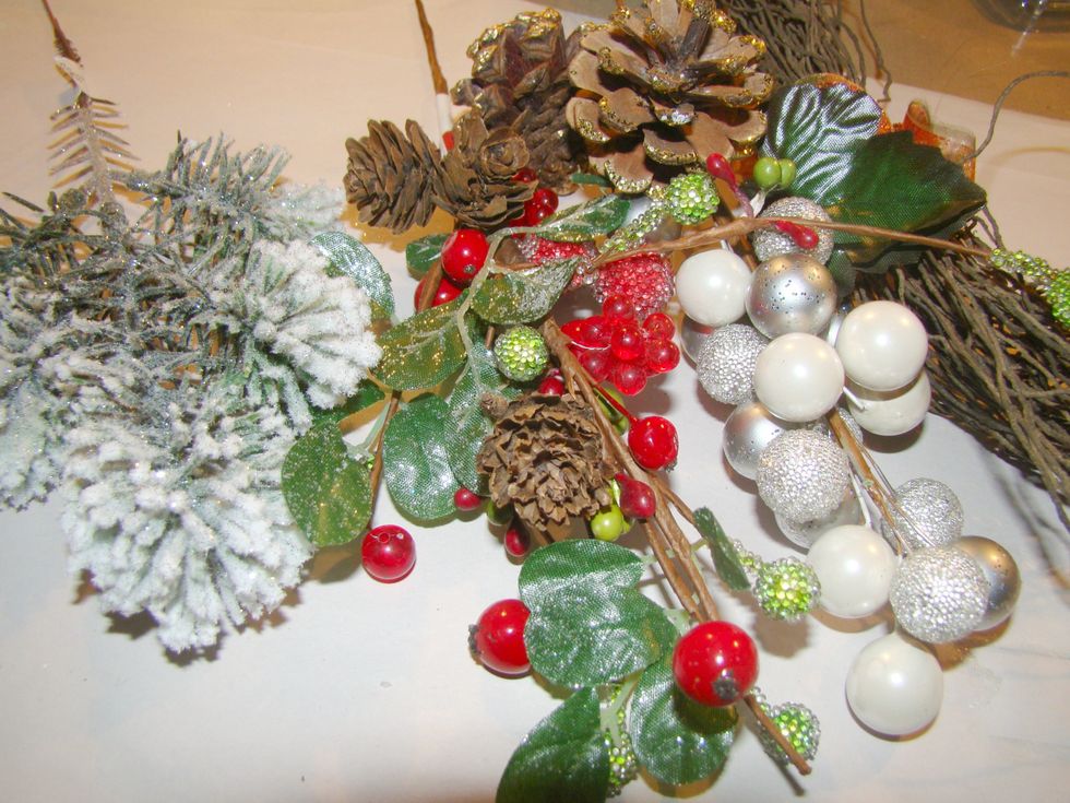 Cut sprigs of your florals to decorate the tops of your ornaments. Using a glue gun, embellish around the top.