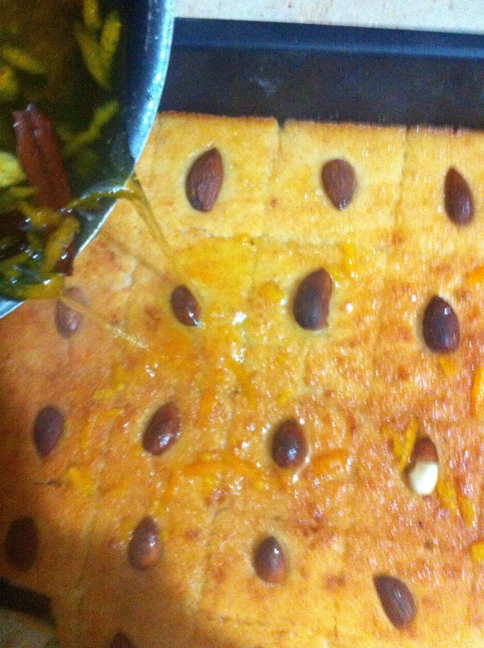 Cut squares of the semolina cake so that it absorbs the syrup nicely. Pour hot syrup when it's done over it. You can strain the syrup to get rid of orange rind. Optional
