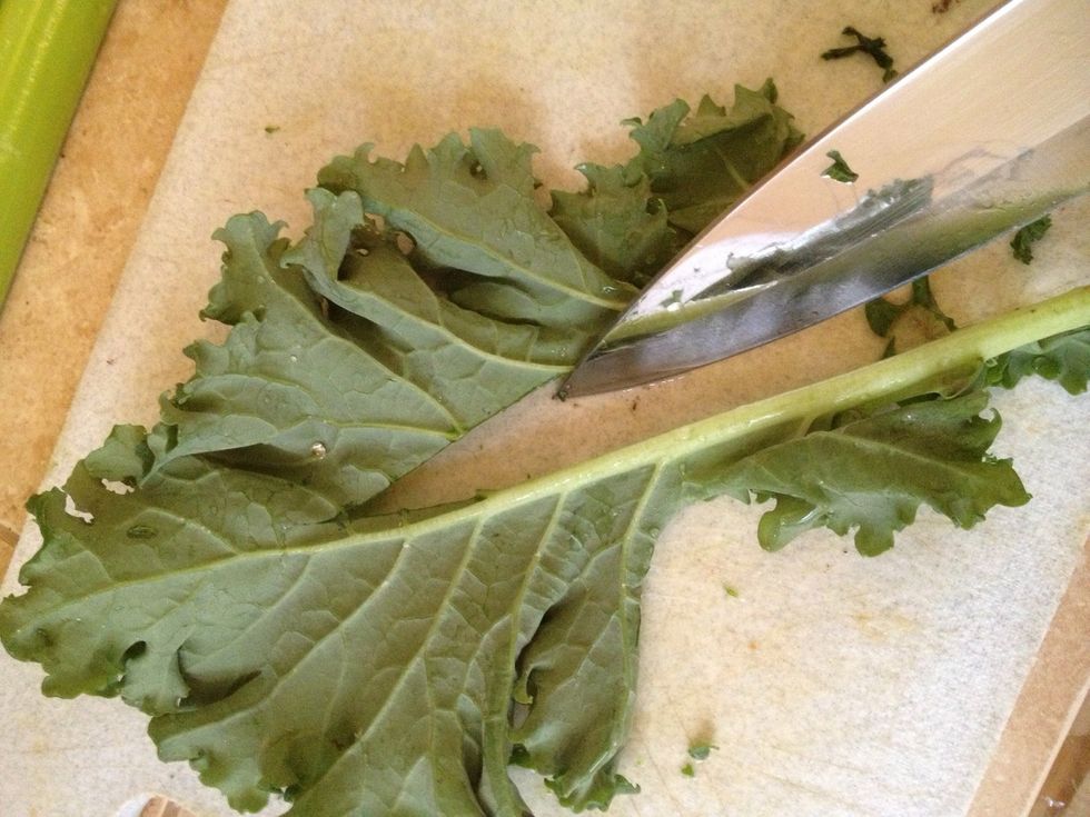Cut stalks out of kale leaves.