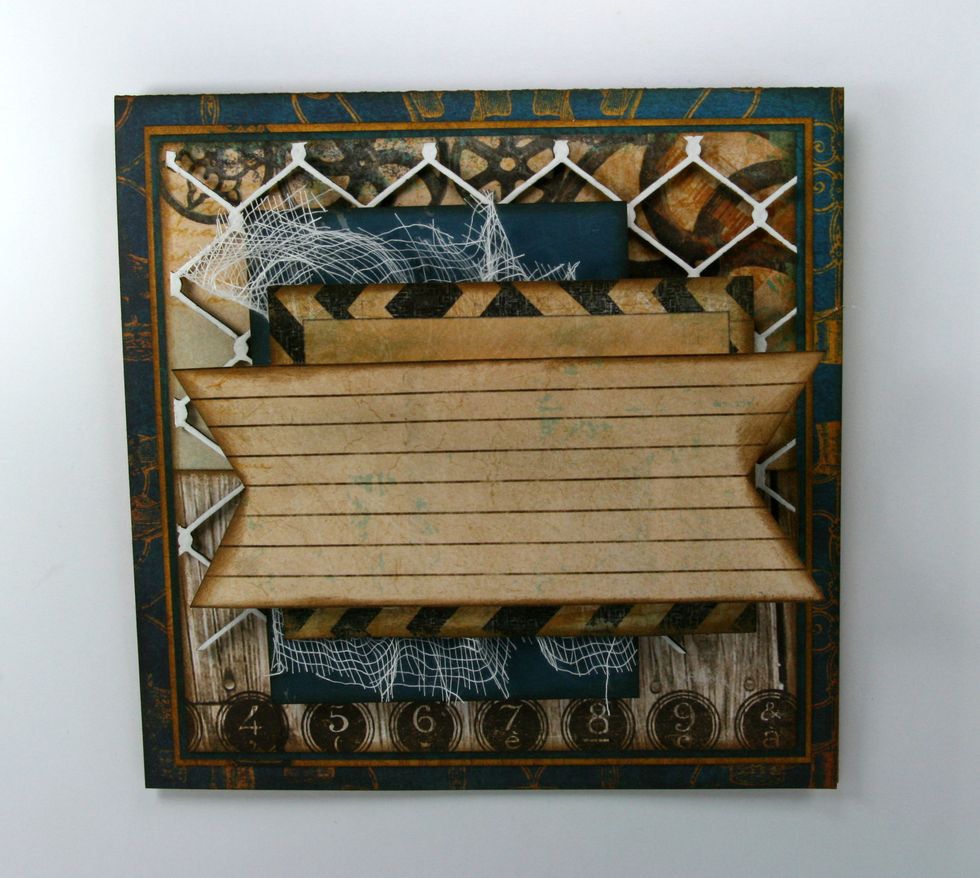 Cut strip of lined paper from the journal tag page and cut dovetail ends. Ink well and attach with foam spacers.