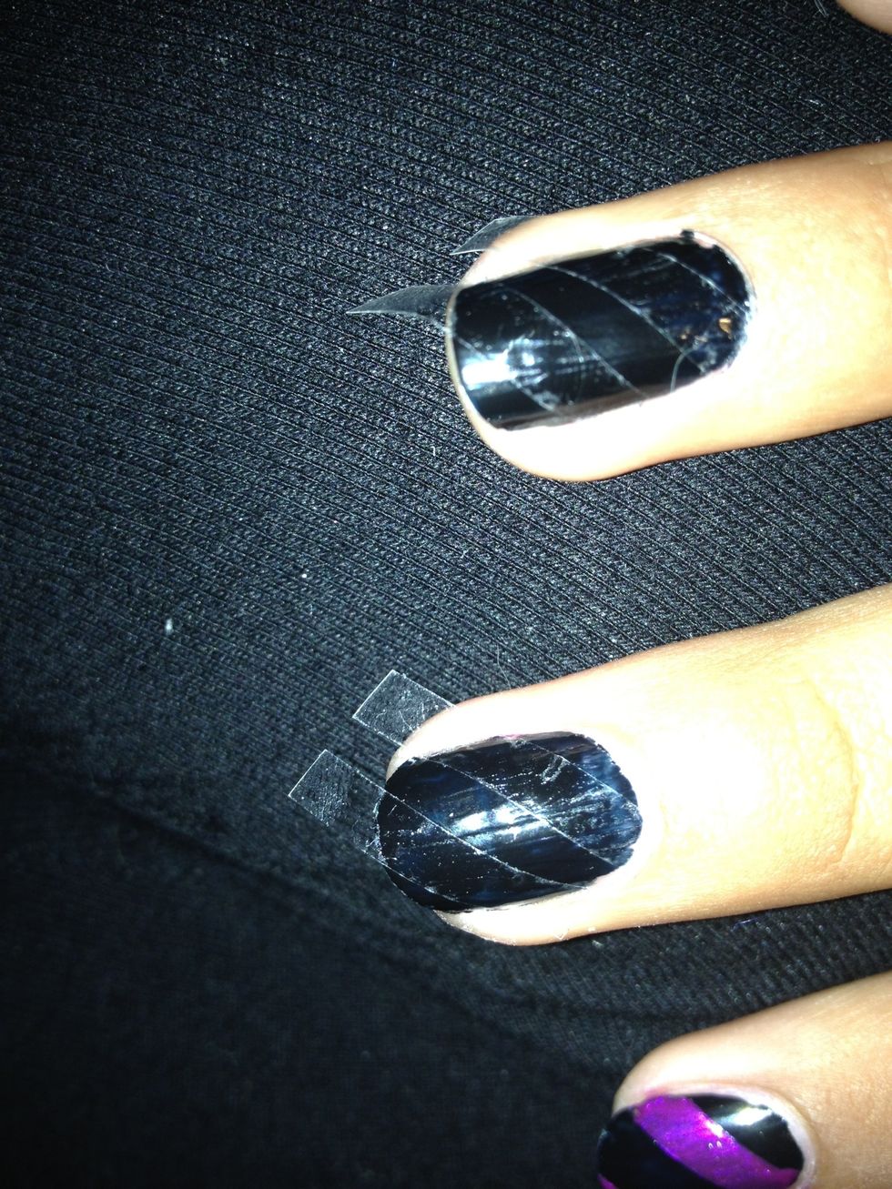 Cut strips of tape depending on how many or how thick you want your stripes. Try to make them the same angle on each nail. Make sure the tape is properly sealed on all sides.