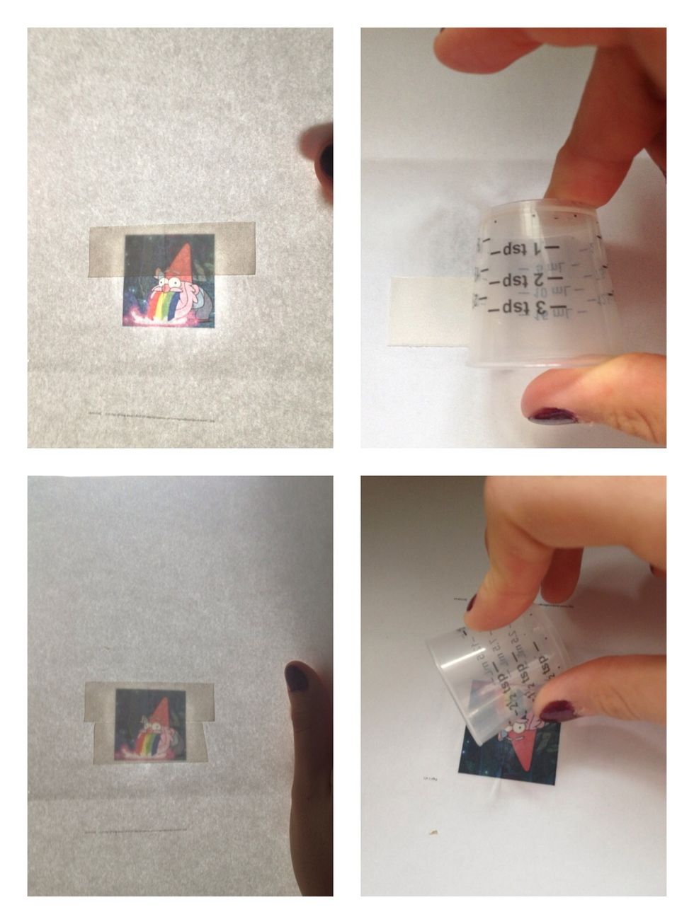Cut strips of two sided tape and stick that onto the back of the photo. Check that it's placed correctly by holding the photo against a light. Smooth the photo with a round object.