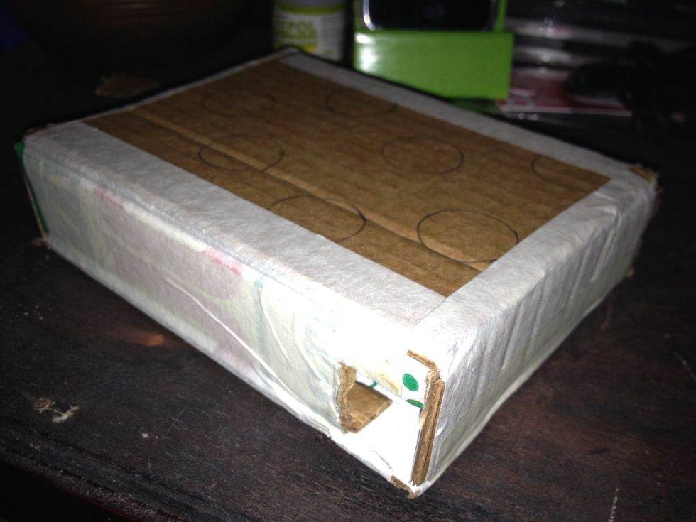 Cut tabs and create the box using maskin tape, cut a little hole to extract the ball