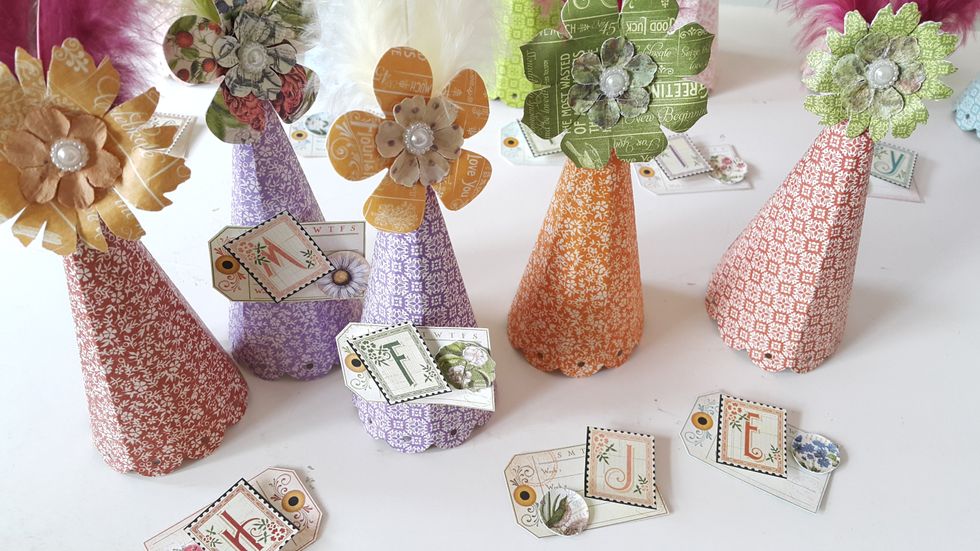 Cut tags from those left behind scrap papers, embellish with Graphic 45 cardstock alphabet stickers and banners