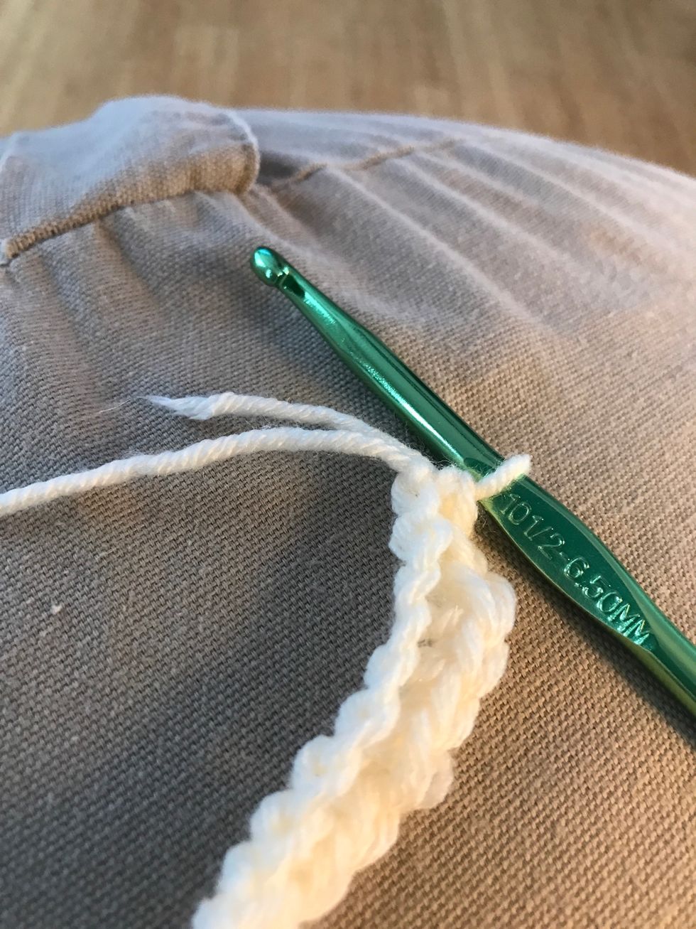 Cut the access yarn off and create and knot connect both sides by tying a knot.