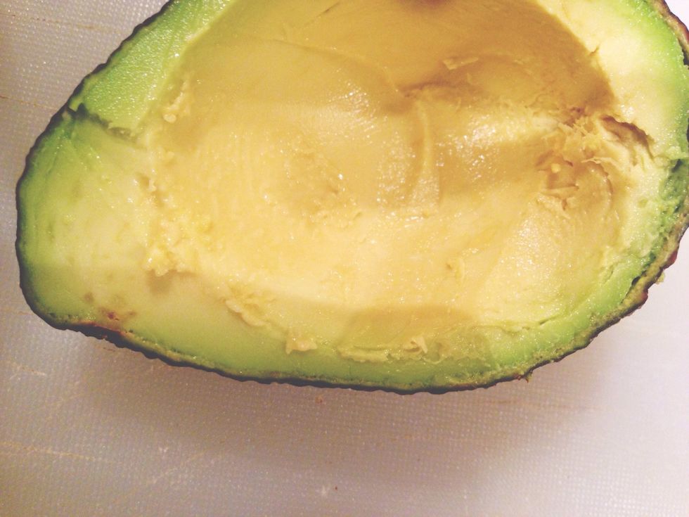 Cut the avocado in half and remove 1 tablespoon avocado from the middle to make room for the egg.