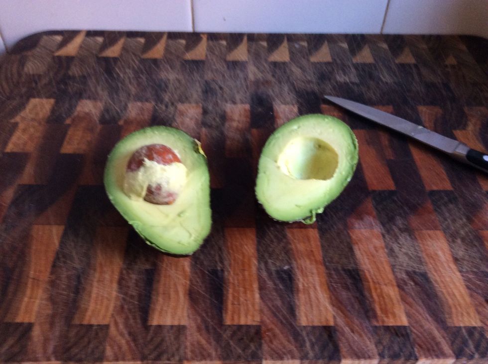 Cut the avocado in half