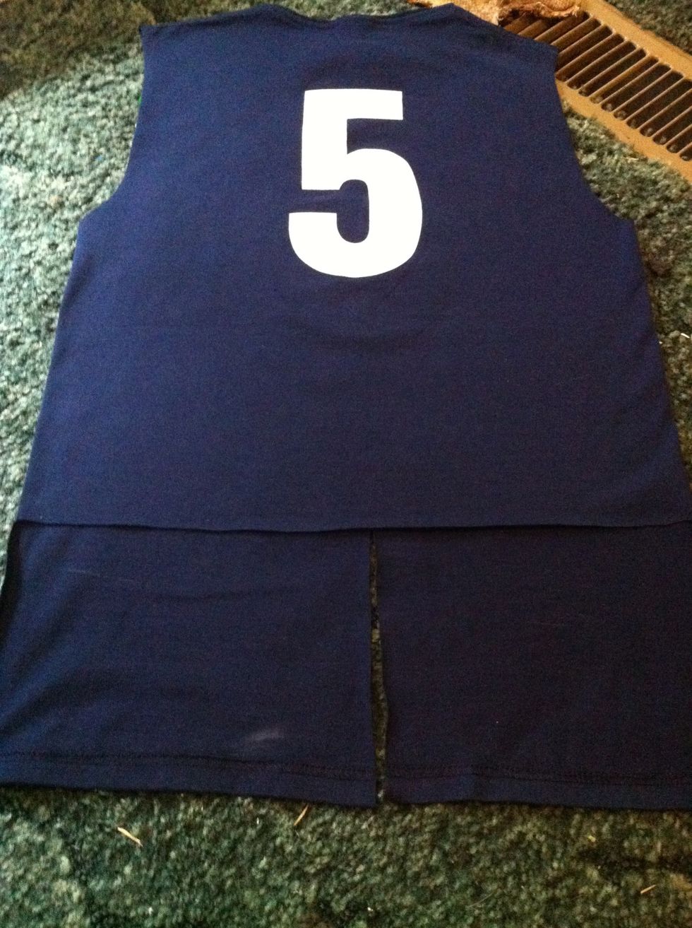 Cut the back straight across at about the same height were the front slit stops *the shirt will look better this way when you tie it*