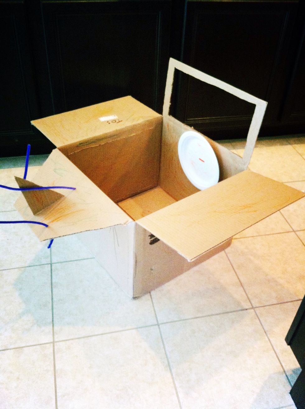 Cut the back tail flap, tapering it. Attach a paper plate steering wheel with a pipe cleaner.