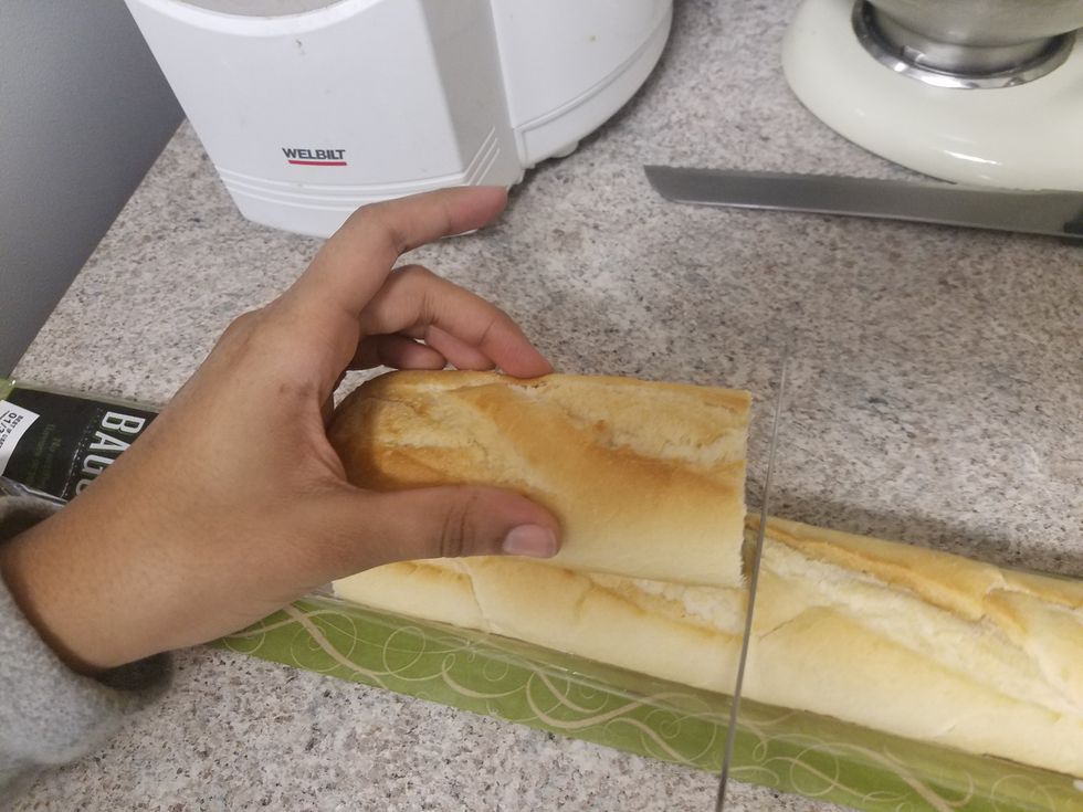 Cut the baguette into 4 pieces. Use a long knife to cut out the insides, leaving some bread along the edges. Pull out the loose bread to leave hollow bread quarters. Set aside