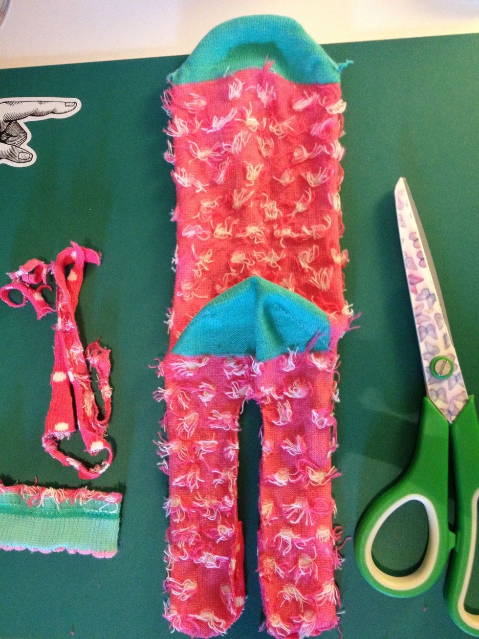 Cut the base of the sock off and cut around the legs that you drew. It doesn't matter if they aren't straight as you can sort this out with stitching.