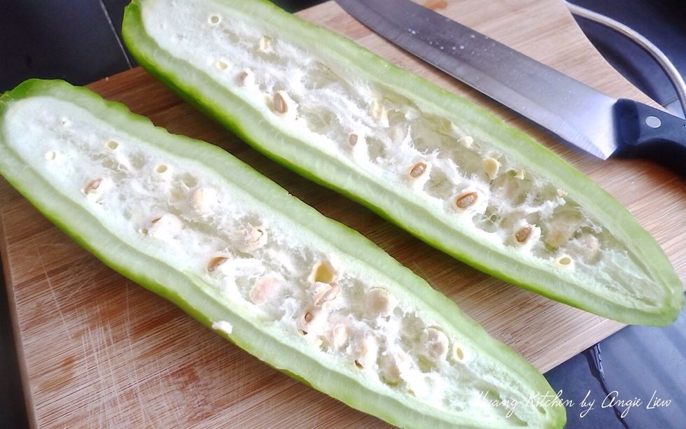 Cut the bitter gourd in half lengthwise.