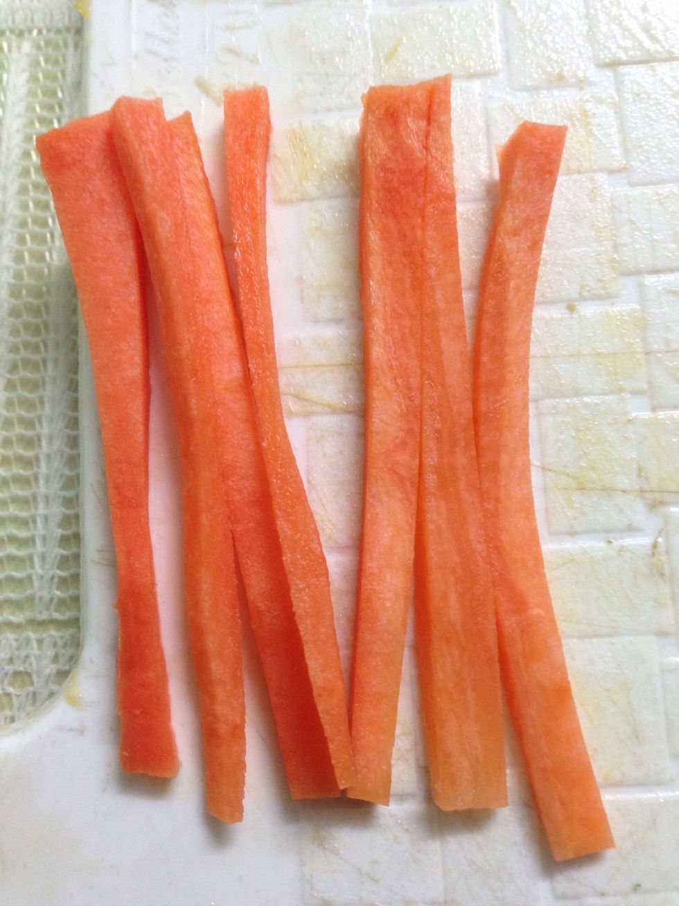 Cut the carrot into thin slices (julienne) to make its whiskers.