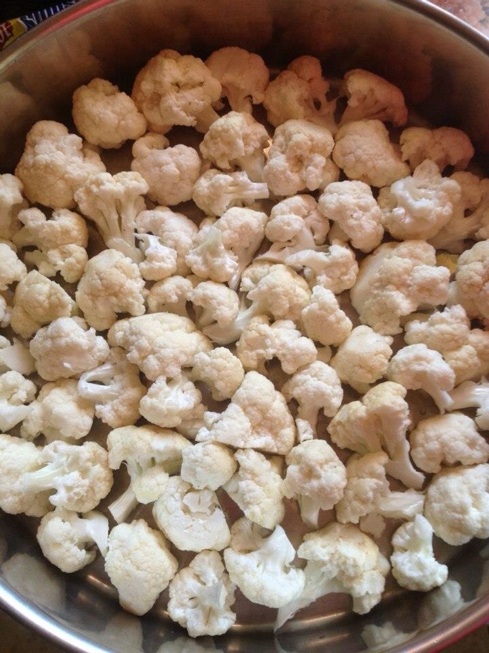 Cut the cauliflower into pieces then sprinkle with olive oil