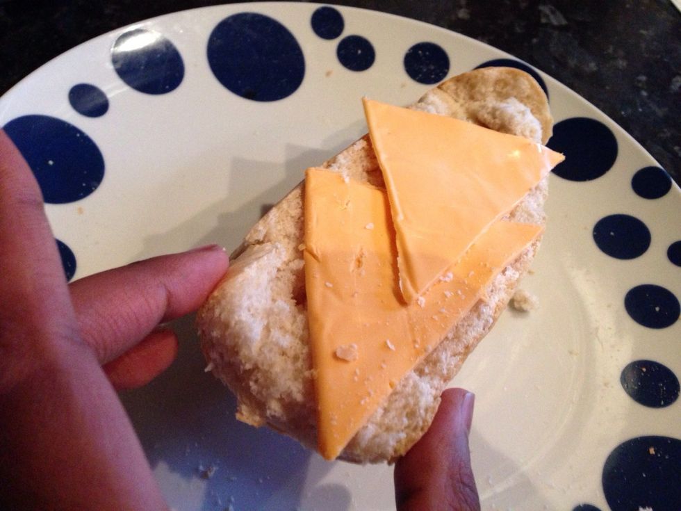 Cut the cheese in half and place it on the top part of the loaf. You can heat the cheese in the microwave or oven for half a minute.