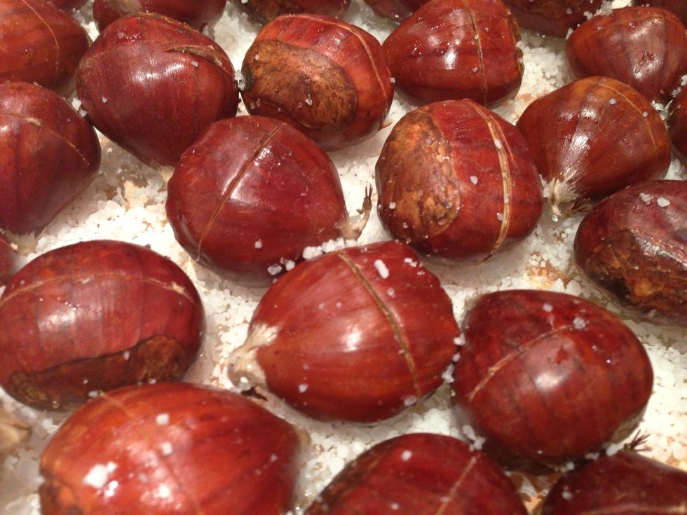 Cut the chestnuts with a slice across the middle and sprinkle also some salt over the washed chestnuts.