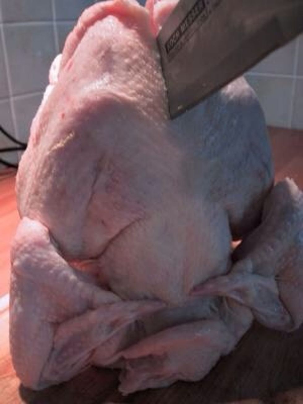 Cut the chicken in half, along the back