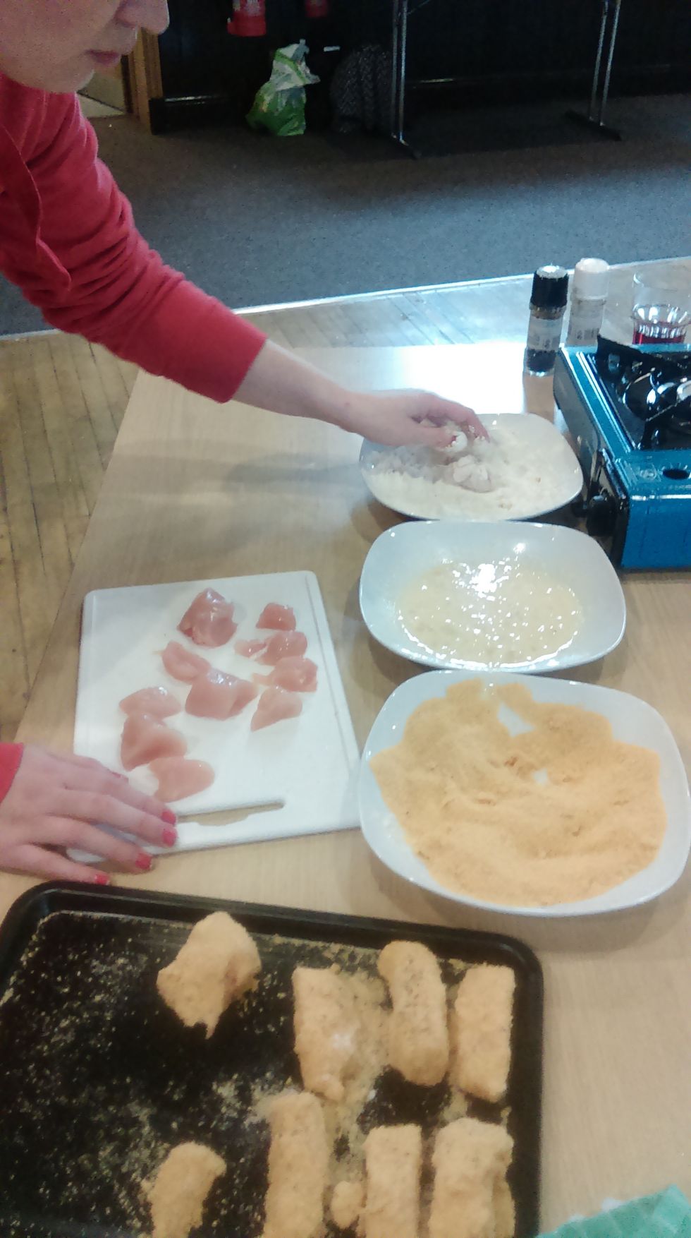 Cut the chicken or fish into nugget size pieces. Put some flour onto a plate, also egg and breadcrumbs. Dip chicken or fish into flour, then into egg and finally coat with the breadcrumbs.