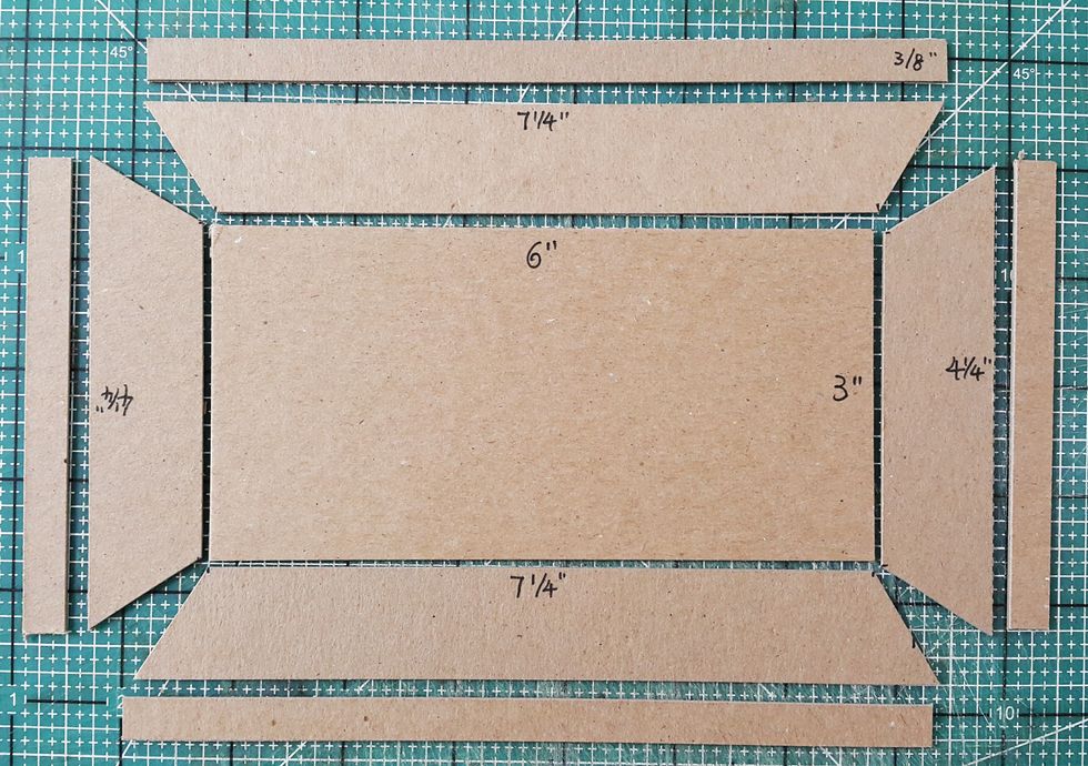 Cut the chipboard into shape and add chipboard pieces of 3/8" width for the sides of the roof.