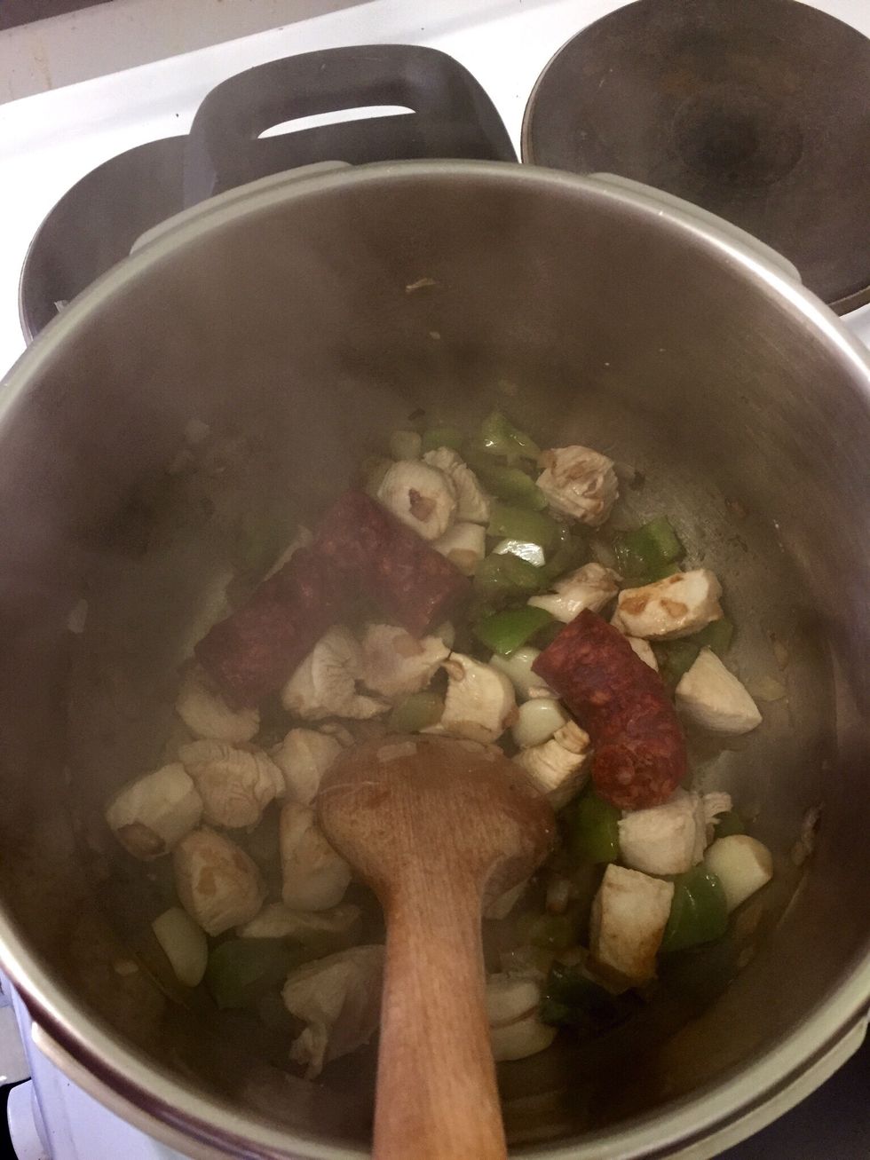 Cut the chorizo in pieces or whole if they are small and cook a bit with everything