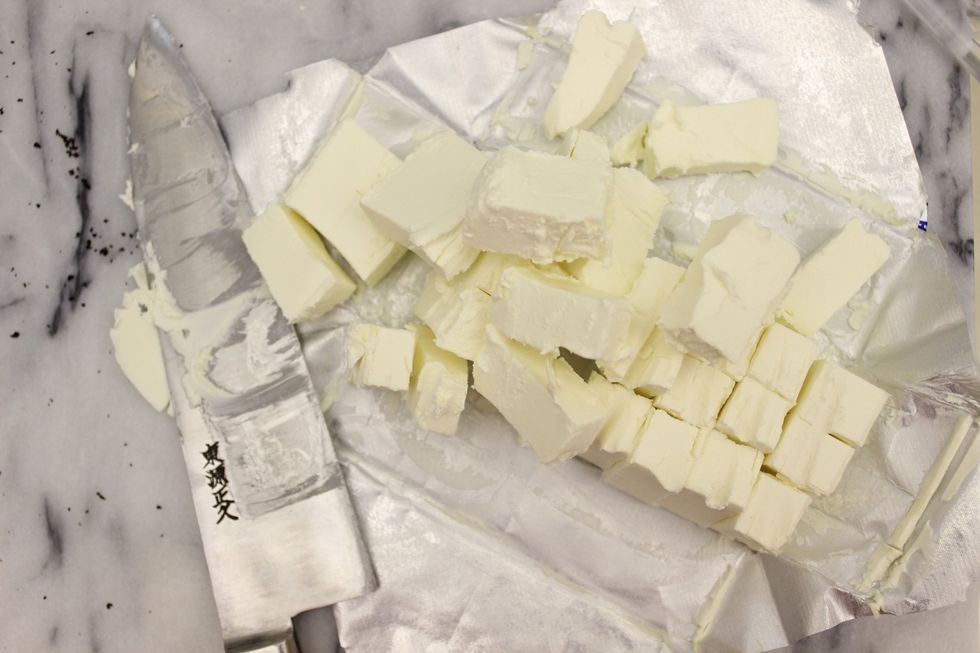 Cut the cold cream cheese into smaller chunks.