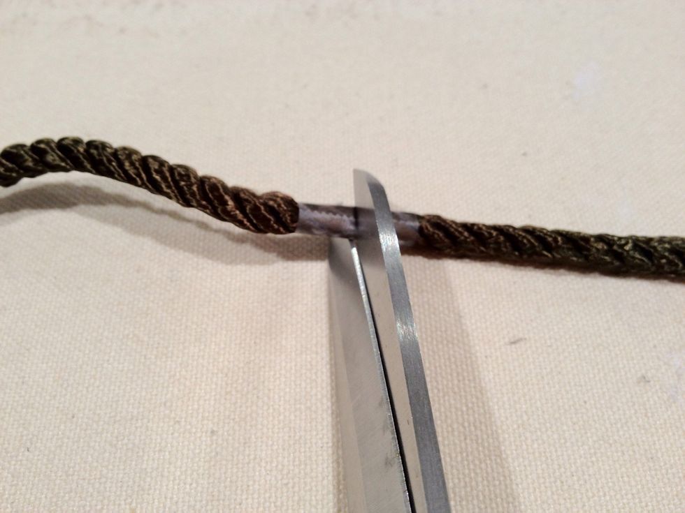 Cut the cord in the middle of the tape as shown.