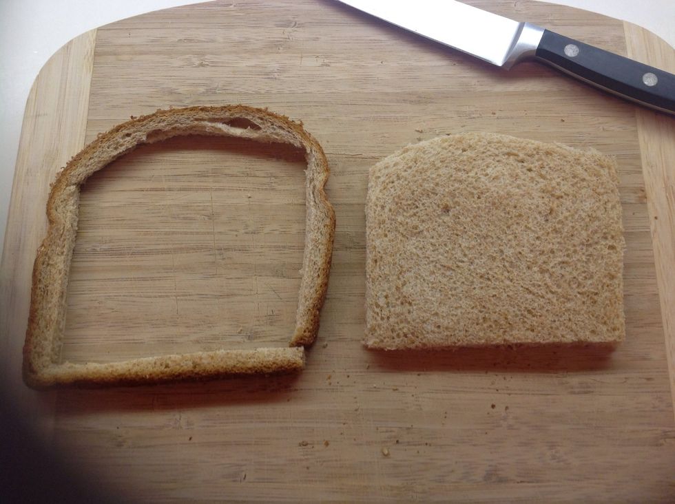 Cut the crusts off of a standard piece of whole wheat bread.