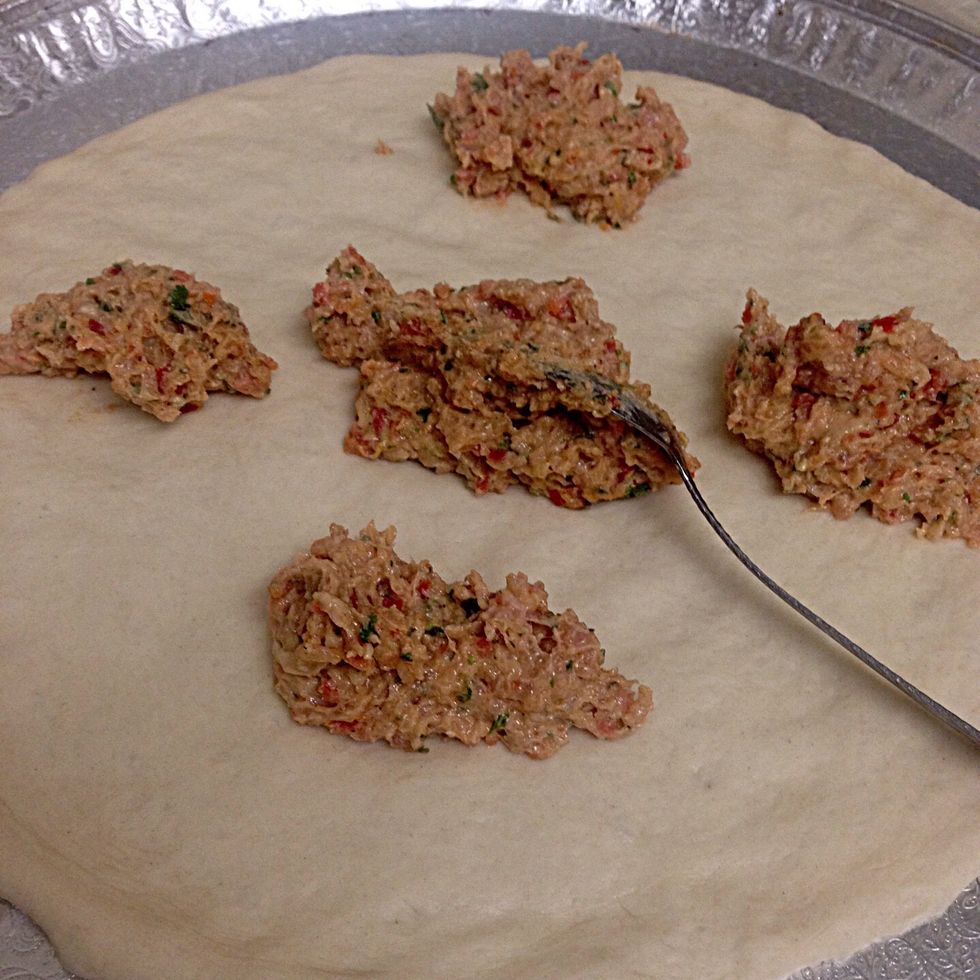 Cut the dough into 2 equal pieces .. and roll out about 10 inch long. Spread the fillings out. I only made one pizza with filling ingredients. The other half of the dough I used it for something else