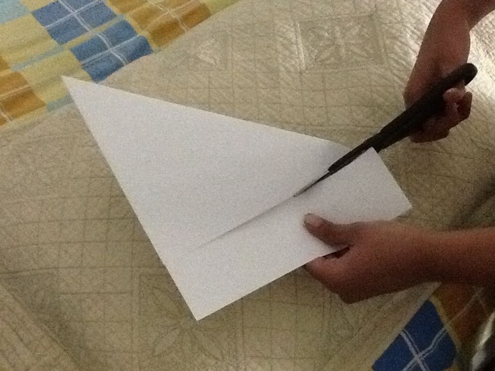 Cut the edge off using a scissor to make a square shaped paper