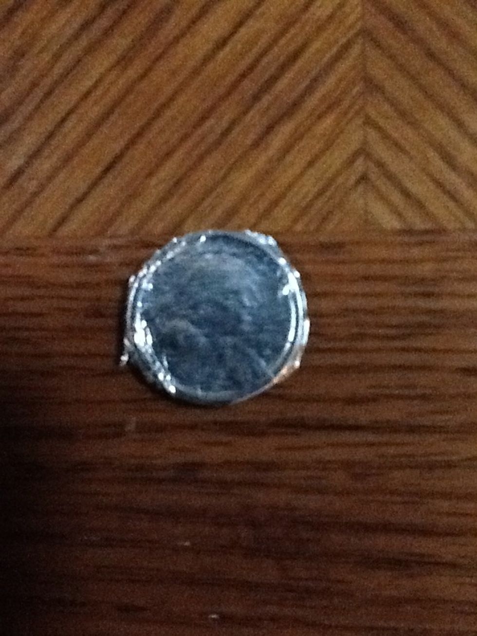 Cut the edges off so it looks like the coin.