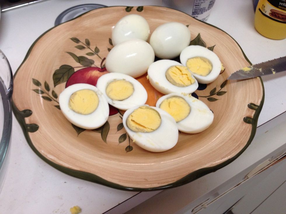 Cut the eggs in half, length wise and scoop out the yellow centers. Place yolks in a bowl.