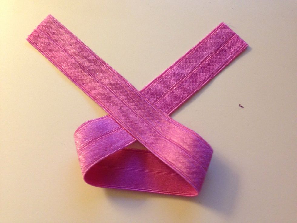 Cut the elastic into 9" segments. Start your knot by crossing the ends over each other with the pretty side facing up.