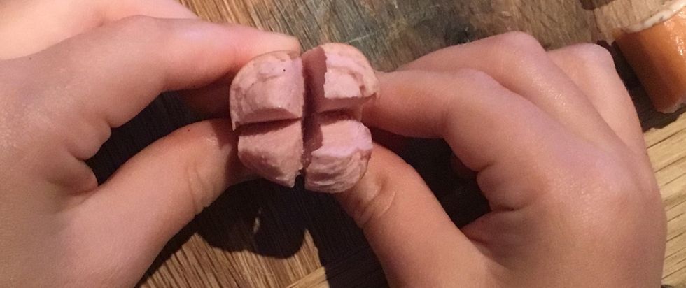 Cut the end of the sausage on the non pointed side so that it looks like the picture