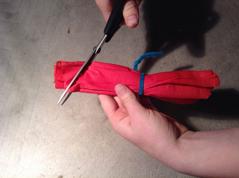 Cut the ends of the paper into a round or pointed shape, depending on how you like your flower petals (we chose round).