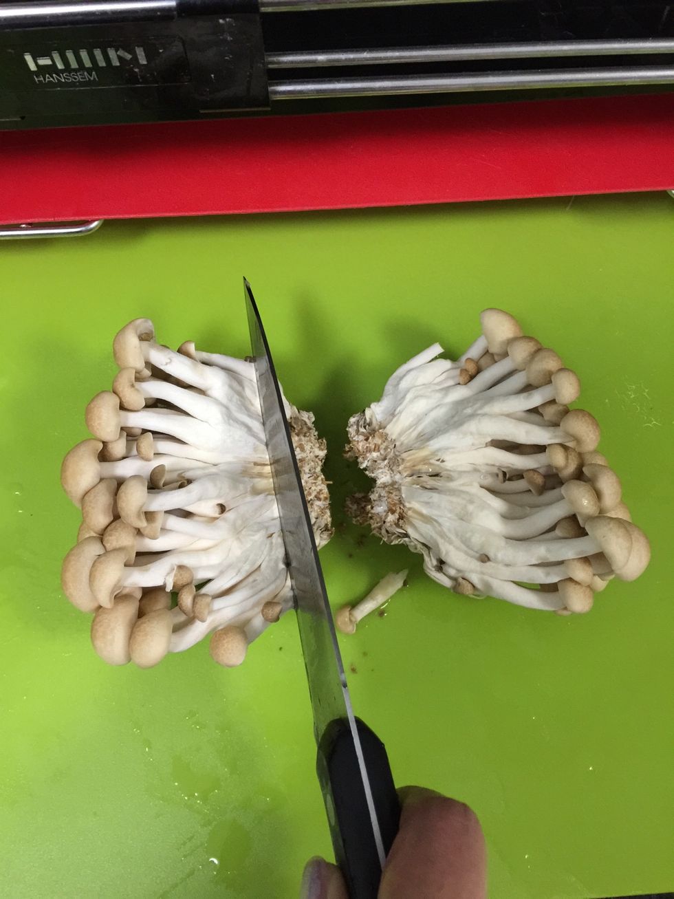 Cut the enoki mushroom. Remove the ugly part.