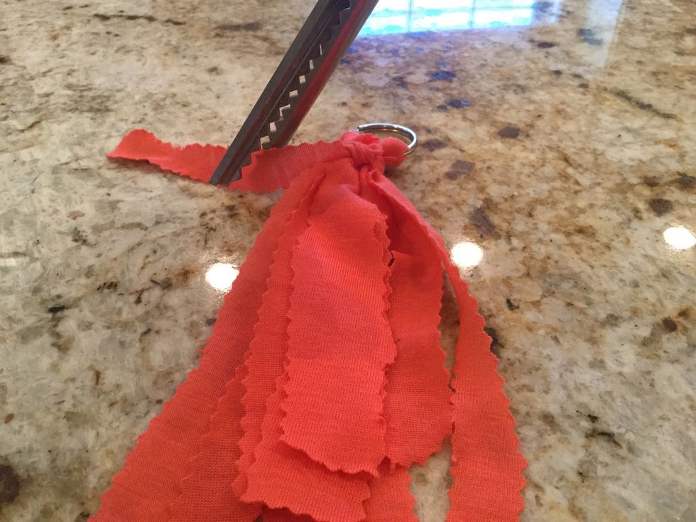 Cut the extra strips off around the knot.