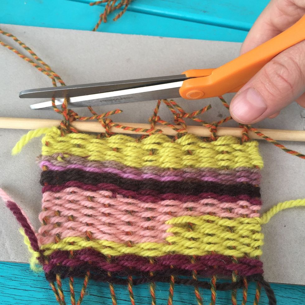Cut the extra yarn off.