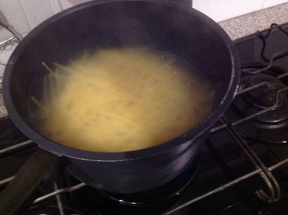 Cut the fettuccine in half and boil it in the water.