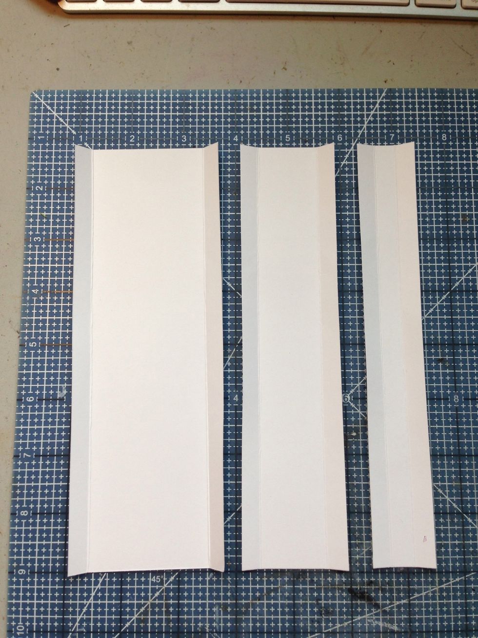 Cut the following from card stock: 1 1/8" x 7 3/4", 1 7/8" x 7 3/4", 2 5/8" x 7 3/4" Score and fold 3/8" from each long side edge.