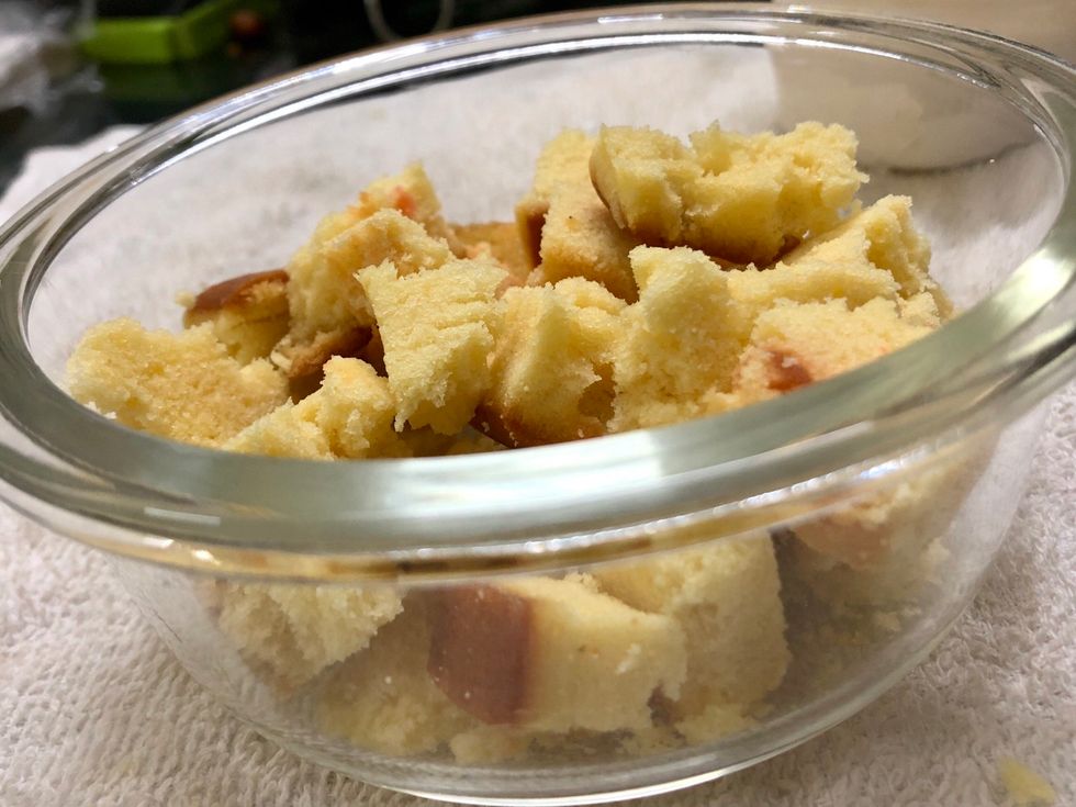 Cut the fruit cake into small cubes and add it to the bowl