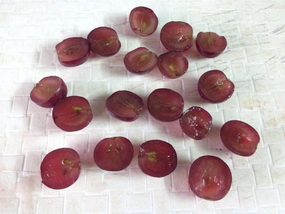 Cut the grapes into half and remove the seeds.