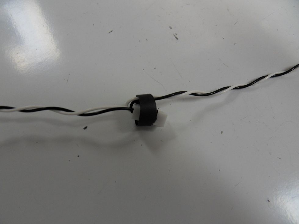 Cut the heat shrink into sections with about a quarter-inch width and string them onto the wire such that they cover the connections as shown above.