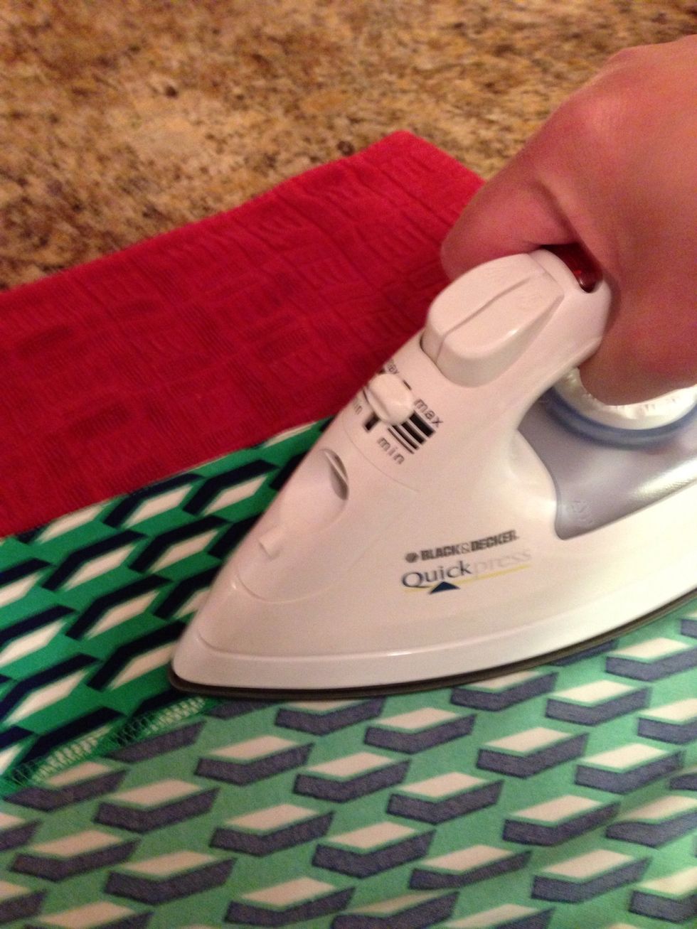 Cut the iron-on hem tape to the length of the hem. Place it in-between the seam, bonding the inside together. Hold a hot iron for at least 30 seconds.