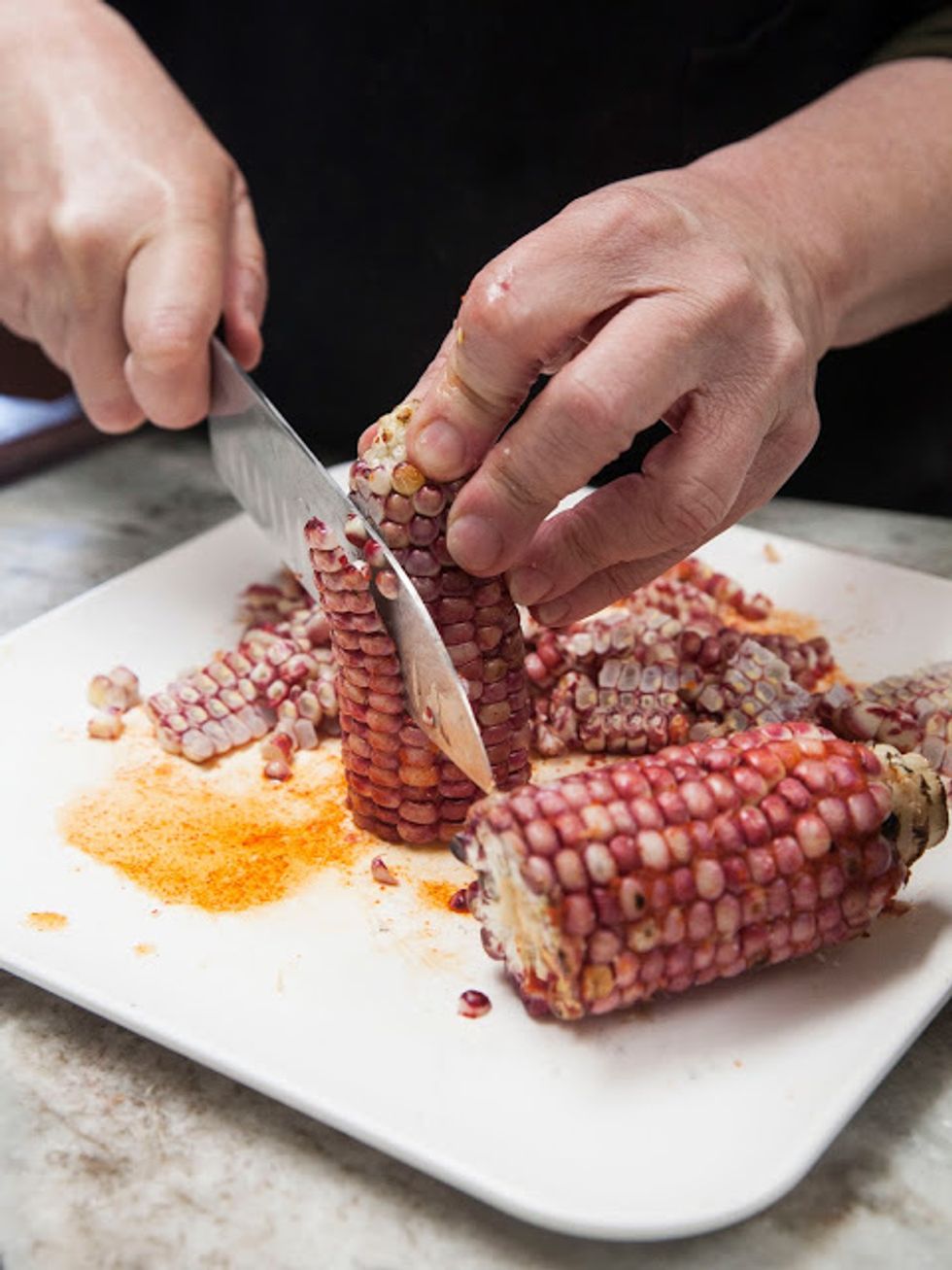 Cut the kernels off of the corn ears and place them in a bowl.